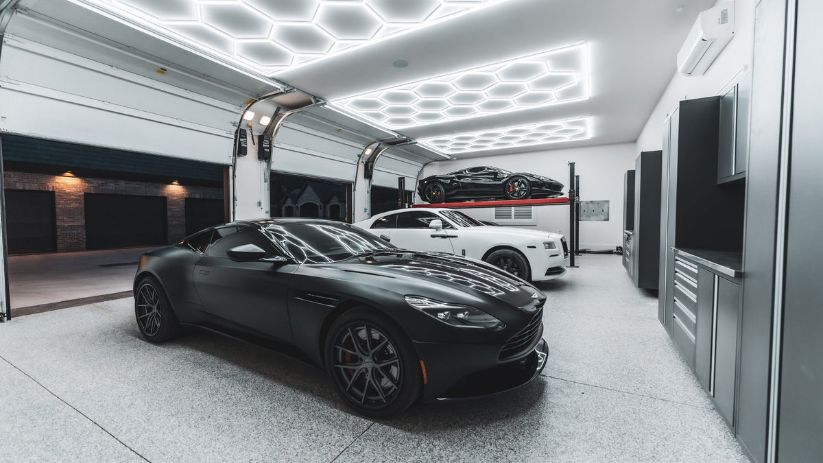 Garage with an Aston Martin under HexGlow hexagon ceiling lights