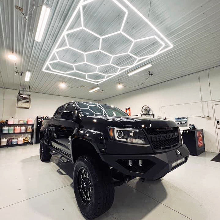 Bright hexagon lighting suspended in auto detailing shop