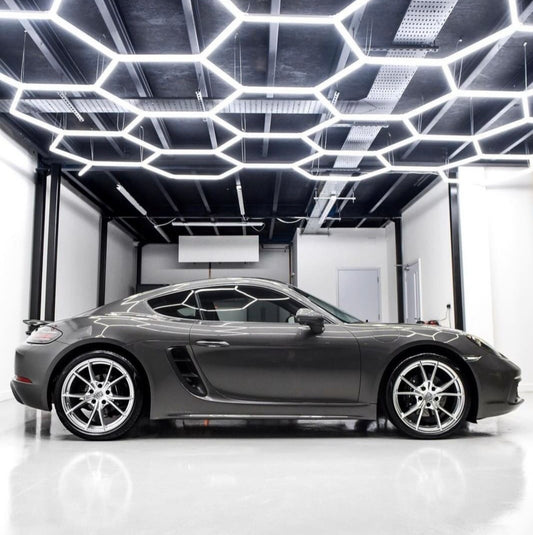 Bright LED hexagon lighting in garage with Porsche